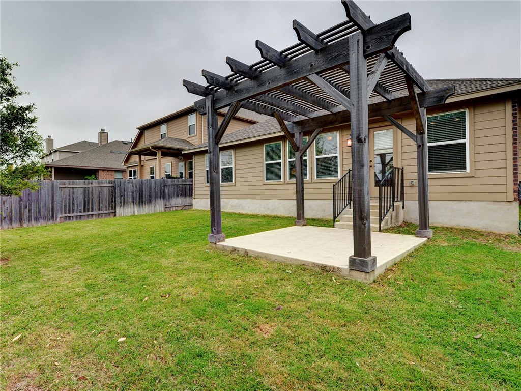 1711 Hidden Springs Path Round Rock, TX 78665 - Photo 29 of 39 a view of a house with a backyard and a patio