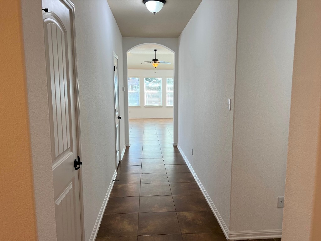 1711 Hidden Springs Path Round Rock, TX 78665 - Photo 6 of 39 a view of a hallway with wooden floor and staircase
