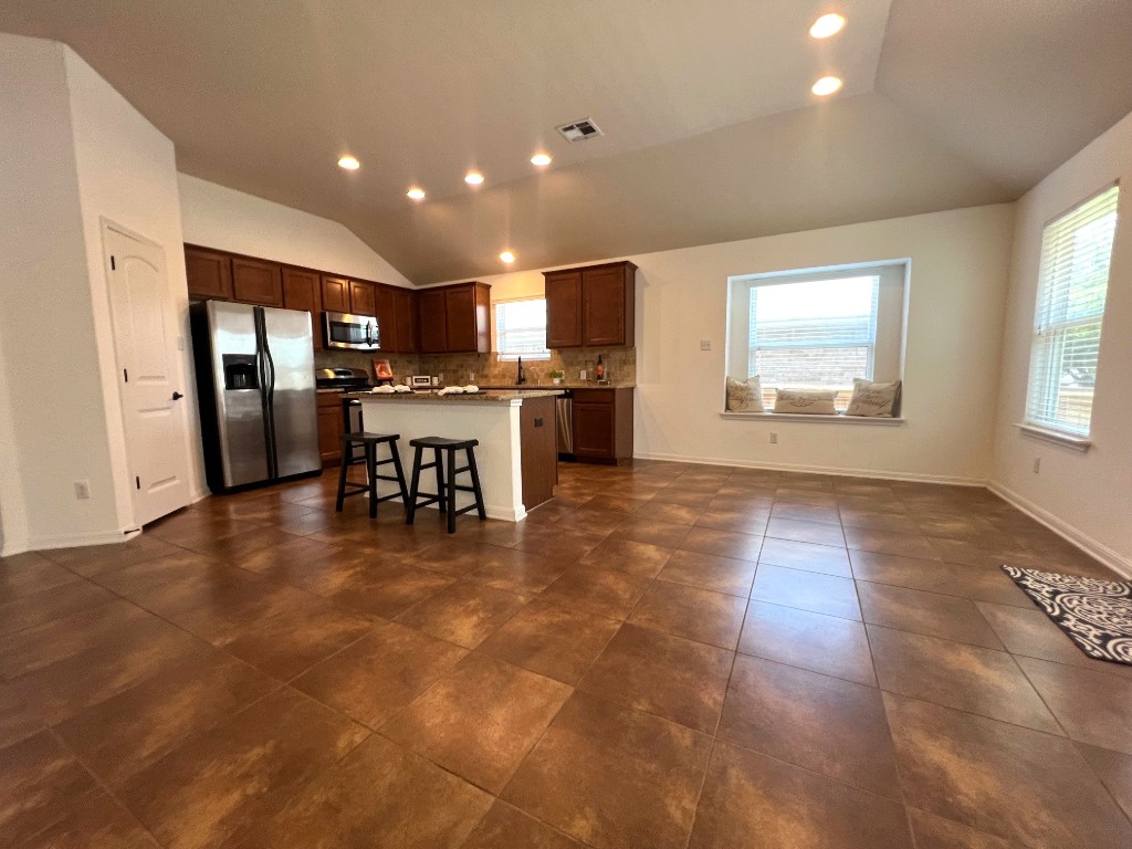 1711 Hidden Springs Path Round Rock, TX 78665 - Photo 9 of 39 a view of a kitchen with dining area refrigerator and window