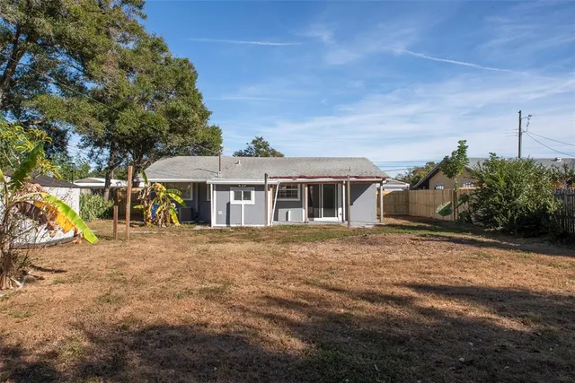 a big house with a big yard and large trees