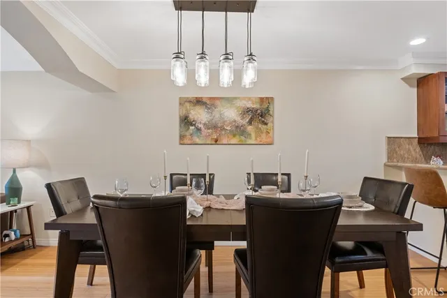 a view of a dining room with furniture and chandelier