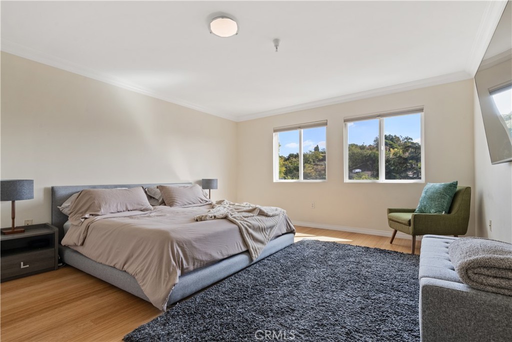 6221 Monterey Road, Unit 304 Highland Park, CA 90042 - Photo 24 of 33 a bedroom with a bed and wooden floor