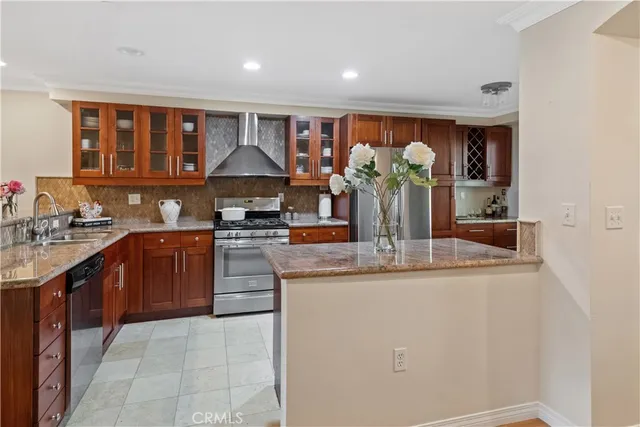 a kitchen with stainless steel appliances granite countertop a sink and cabinets