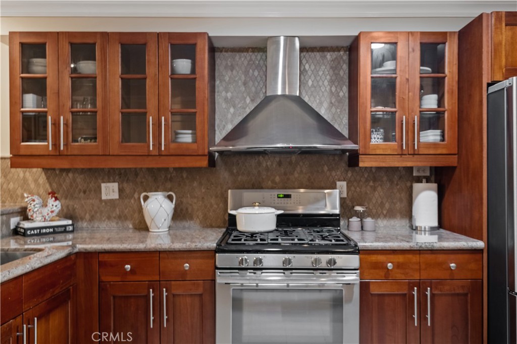 6221 Monterey Road, Unit 304 Highland Park, CA 90042 - Photo 7 of 33 a kitchen with stainless steel appliances granite countertop a stove and a white cabinets