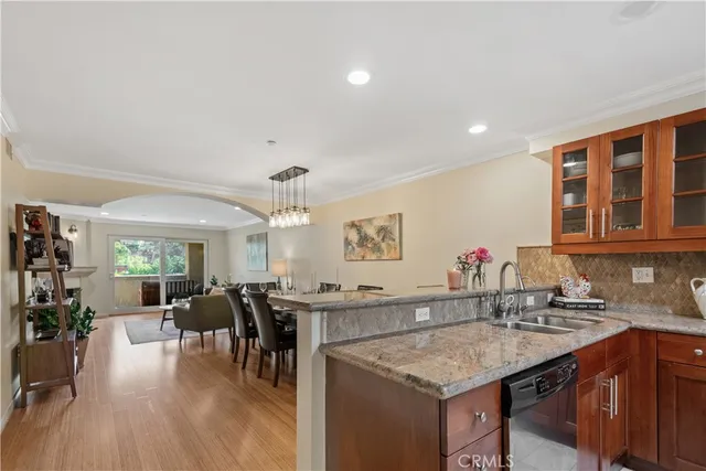 a kitchen with a sink cabinets and wooden floor