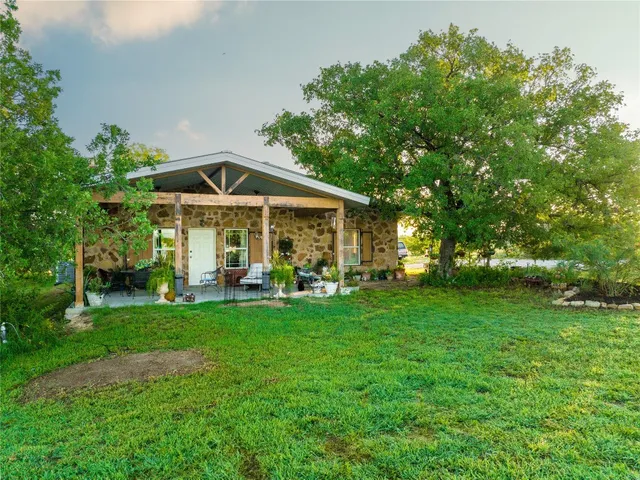 a view of a house with a yard porch and sitting area