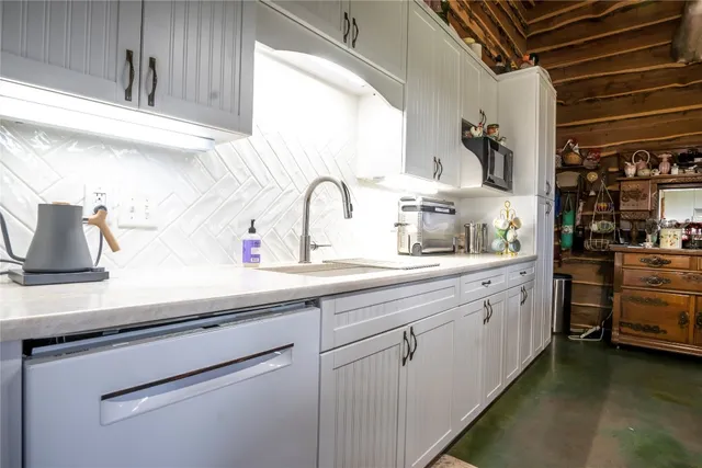 a kitchen with counter top space cabinets and appliances
