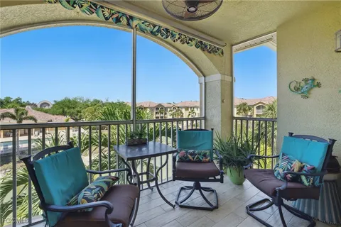 a balcony with furniture and a potted plant