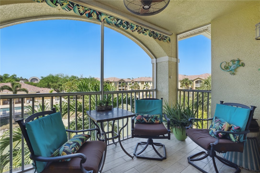 a balcony with furniture and a potted plant