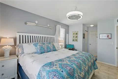 a large bed sitting in a bedroom and chandelier