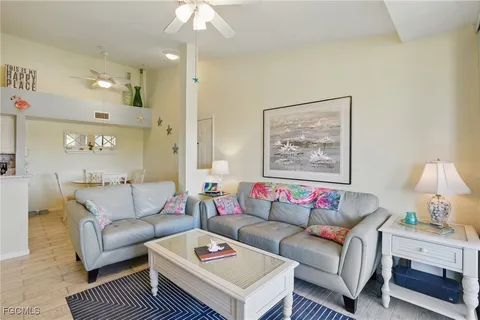 a living room with furniture a rug and a chandelier