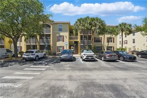 a view of a cars park next to a road