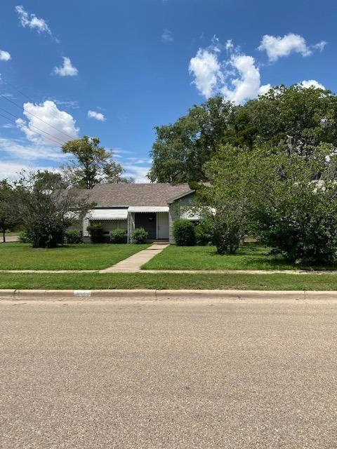 3520 26th Street Lubbock, TX 79410 - Photo 3 of 7 a view of a house with a big yard and potted plants