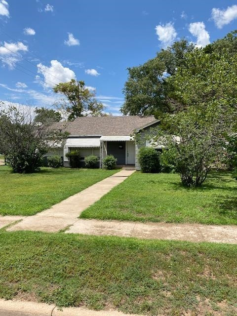 3520 26th Street Lubbock, TX 79410 - Photo 4 of 7 a front view of a house with a yard