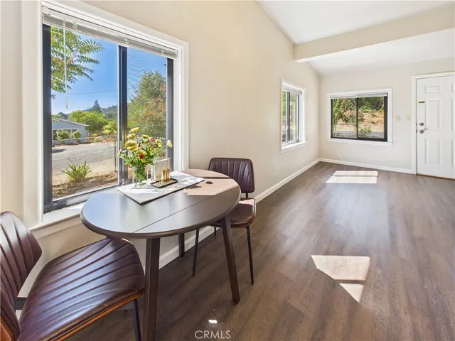 a view of a dining room with furniture window and wooden floor