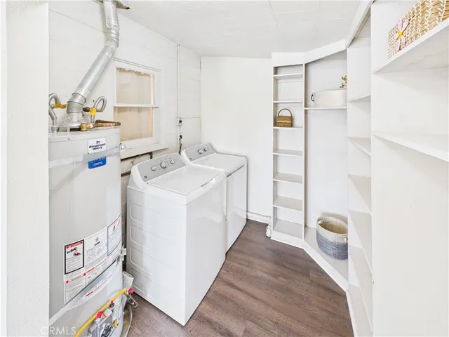 a utility room with cabinets washer and dryer