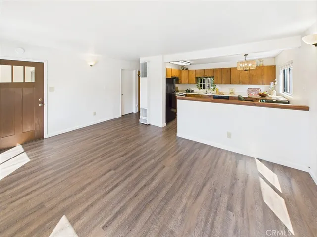 a kitchen with stainless steel appliances a sink cabinets and a window