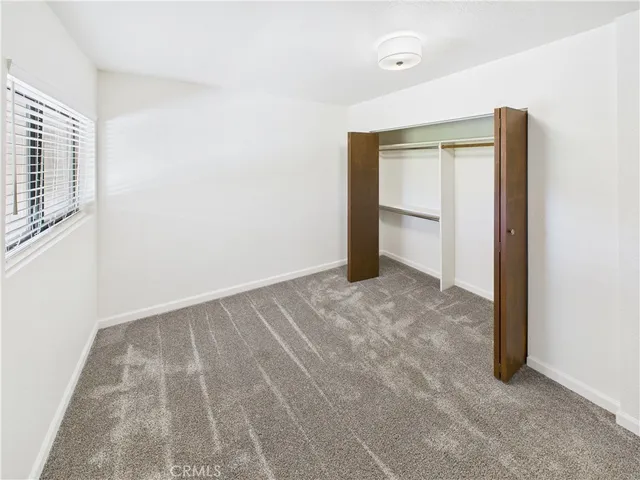 a view of a white house with a yard