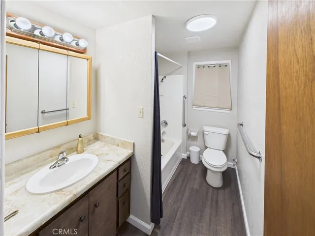 a bathroom with a sink vanity granite and toilet