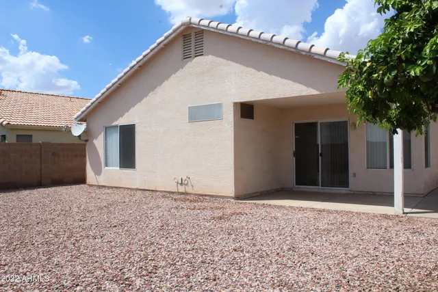 a view of yellow house with a yard
