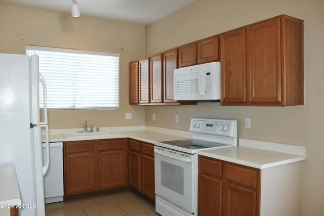 a kitchen with stainless steel appliances a sink a stove and a refrigerator
