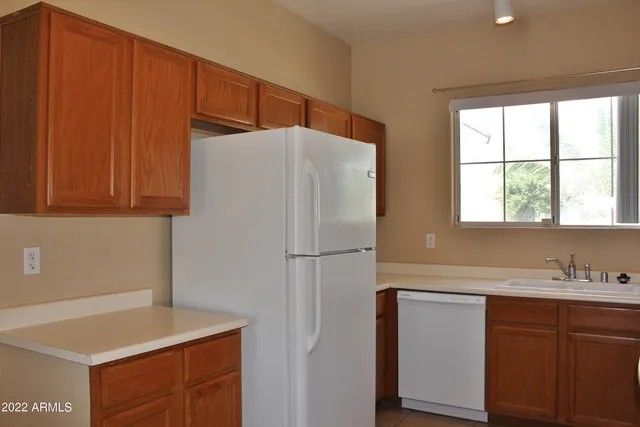 a white refrigerator freezer sitting inside of a kitchen