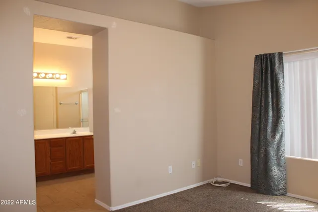 a view of an empty room and an entryway