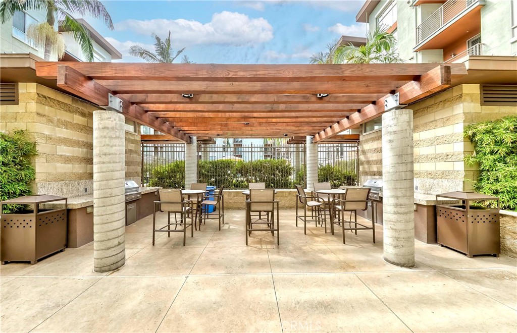 100 South Alameda Street, Unit 321 Los Angeles, CA 90012 - Photo 6 of 17 a view of a patio with dining table and chairs
