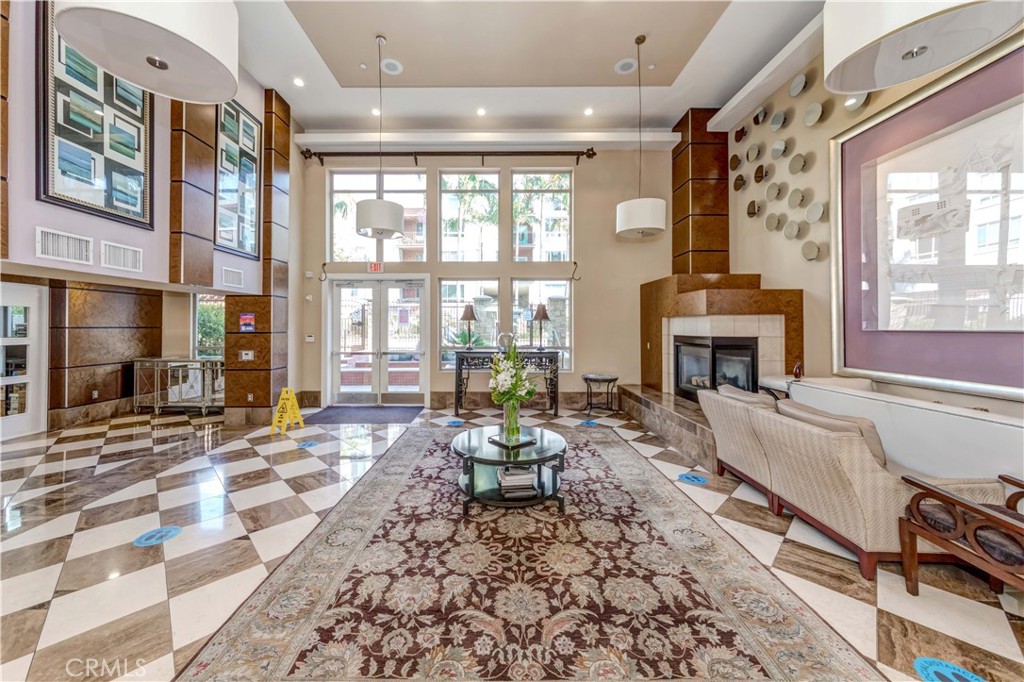 100 South Alameda Street, Unit 321 Los Angeles, CA 90012 - Photo 9 of 17 a living room with fireplace furniture and a large window