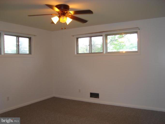 1502 Draper Court Rosedale, MD 21237 - Photo 8 of 10 wooden floor in an empty room with a window