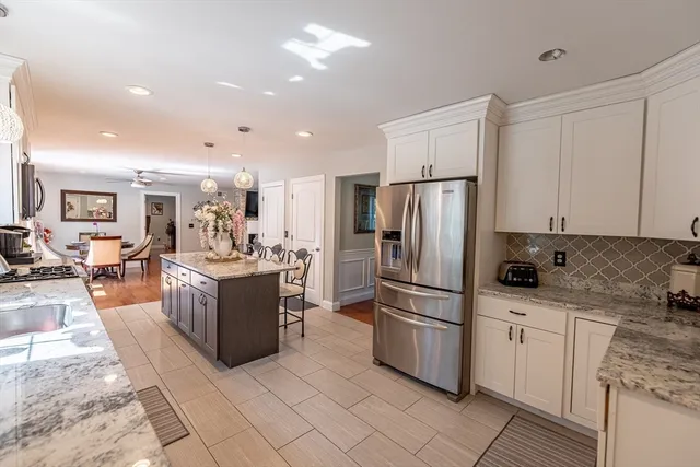 a kitchen with a refrigerator and a stove top oven