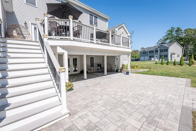 a view of a patio with a dining table and chairs under an umbrella