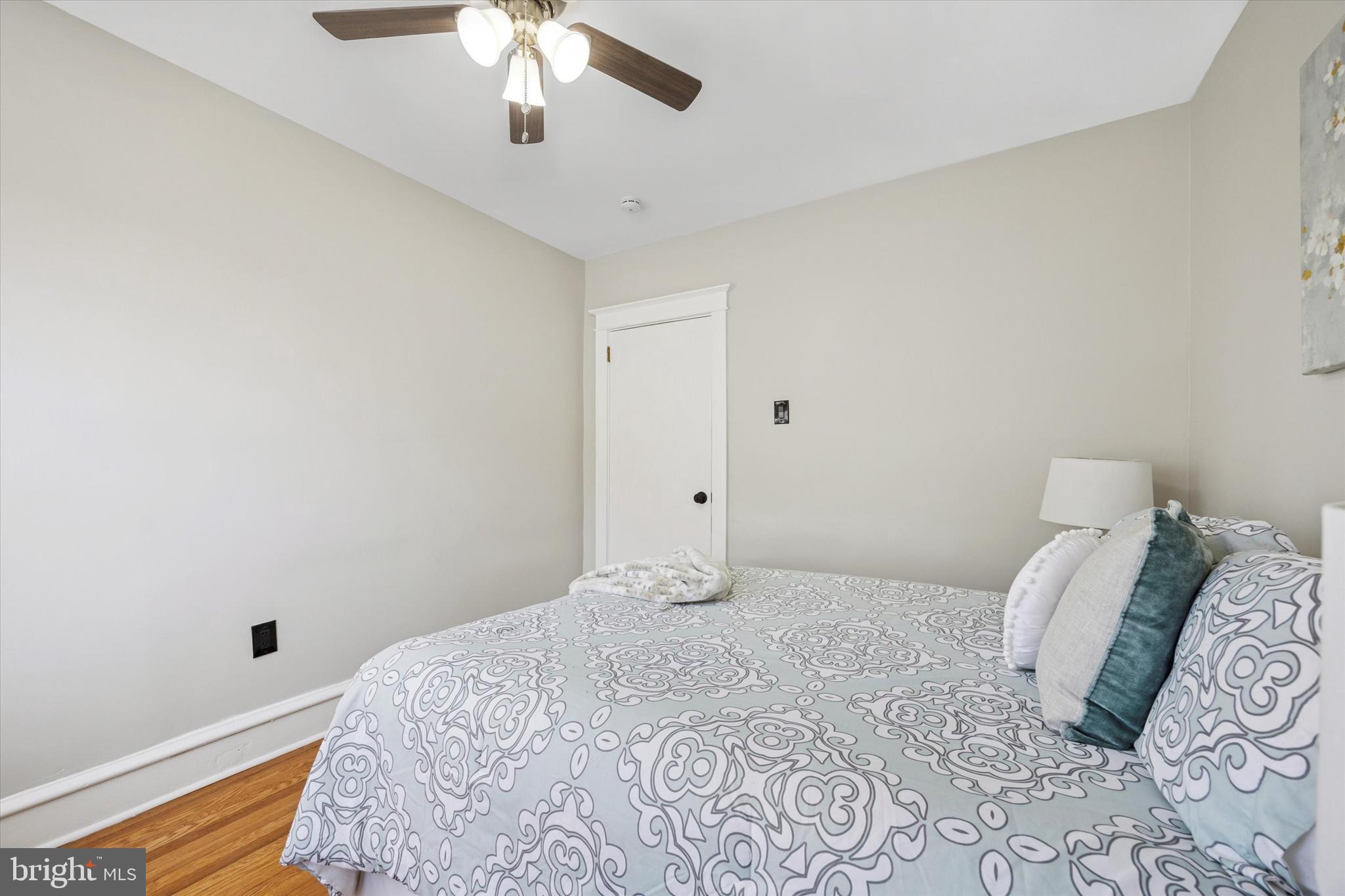 110 Sycamore Road Havertown, PA 19083 - Photo 14 of 25 a bedroom with a large bed and a chandelier