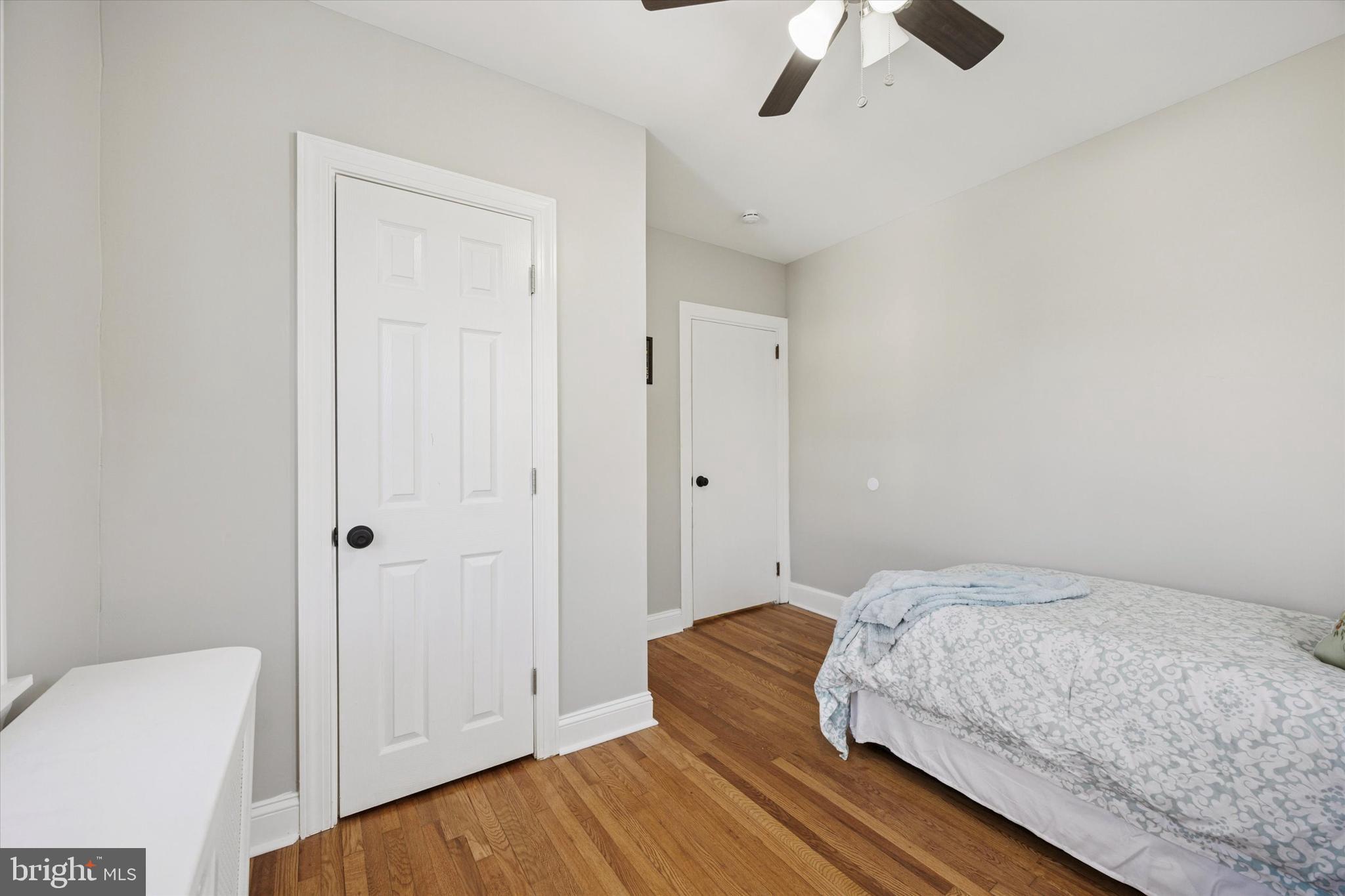 110 Sycamore Road Havertown, PA 19083 - Photo 17 of 25 a bedroom with a bed and a chandelier fan