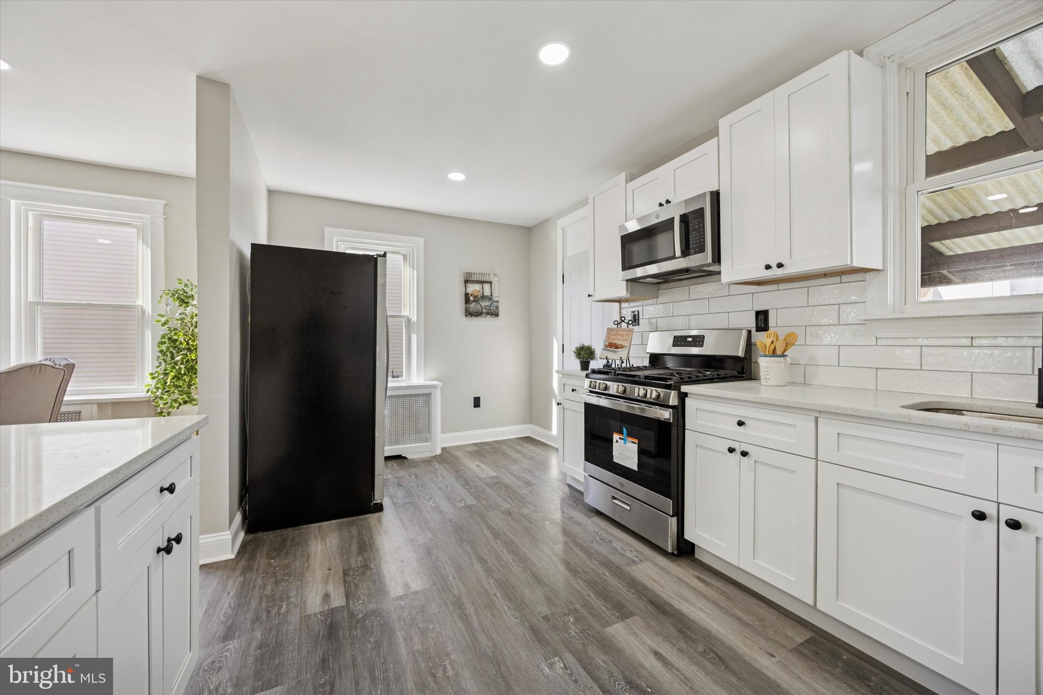 110 Sycamore Road Havertown, PA 19083 - Photo 7 of 25 a kitchen with stainless steel appliances a refrigerator sink and microwave