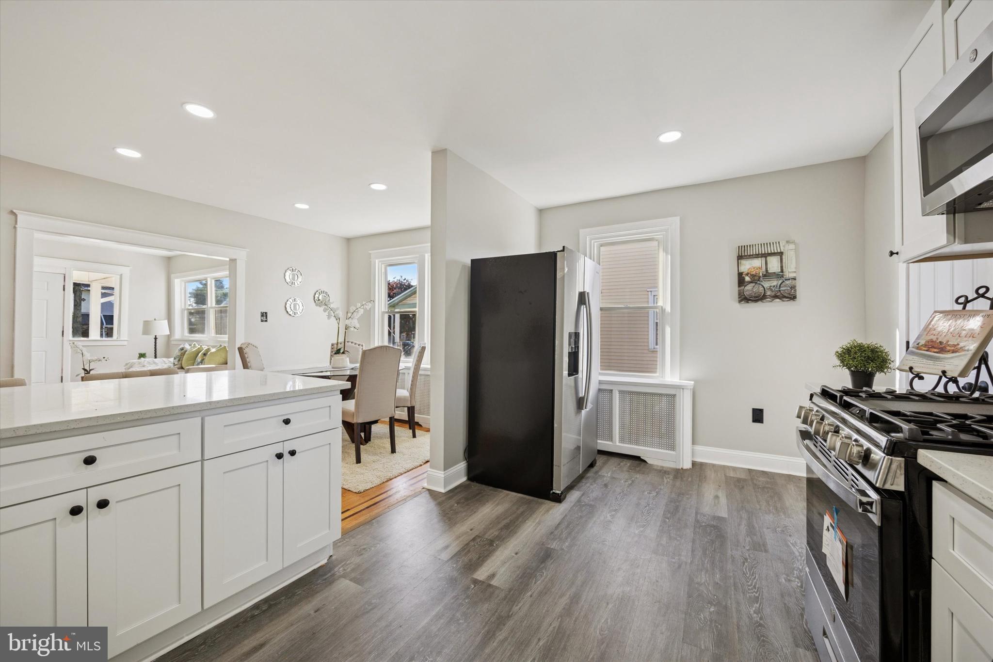110 Sycamore Road Havertown, PA 19083 - Photo 8 of 25 a kitchen with a refrigerator a sink and wooden floor