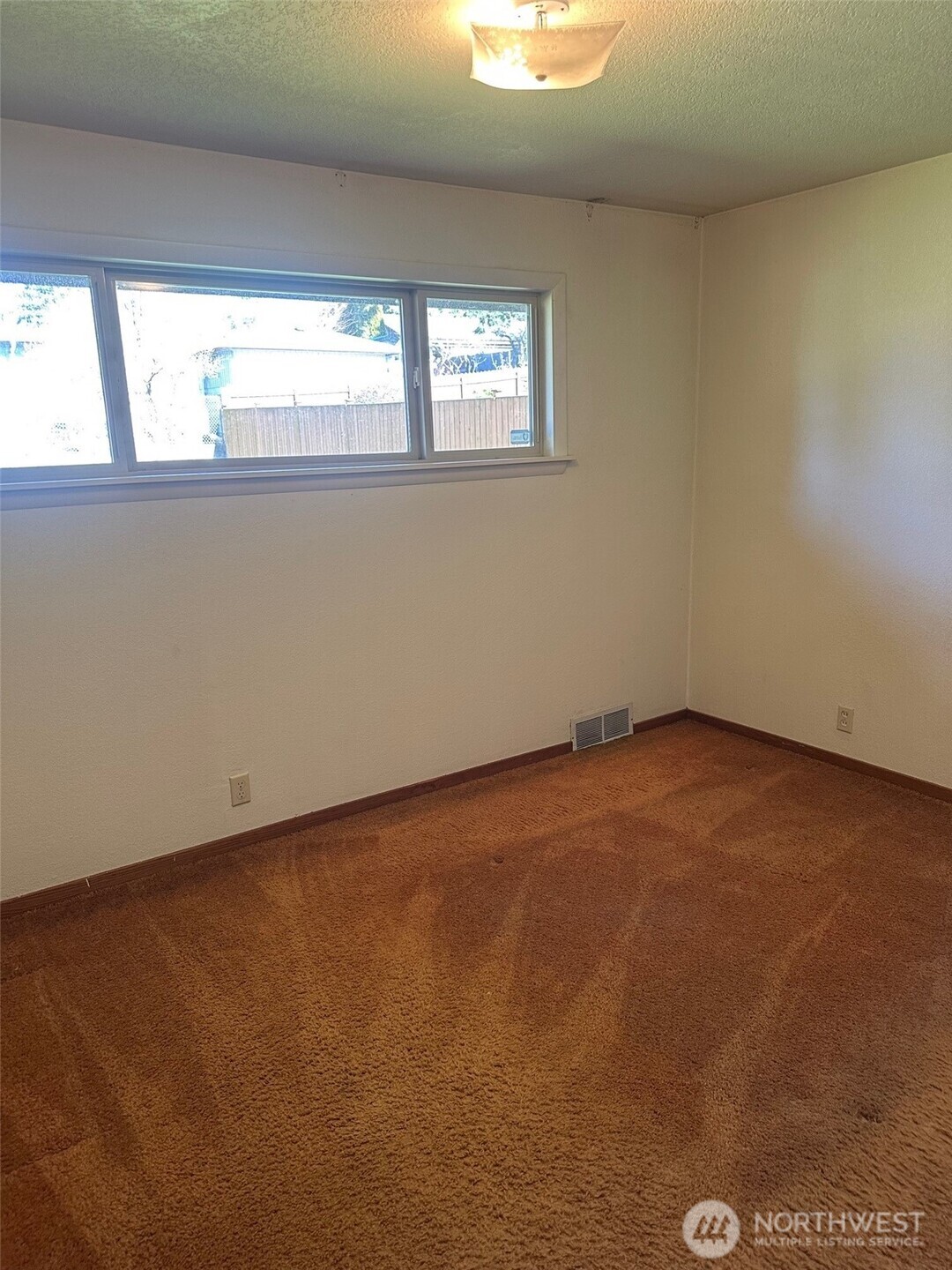 3504 Northeast 135th Street Seattle, WA 98125 - Photo 19 of 35 an empty room with a window