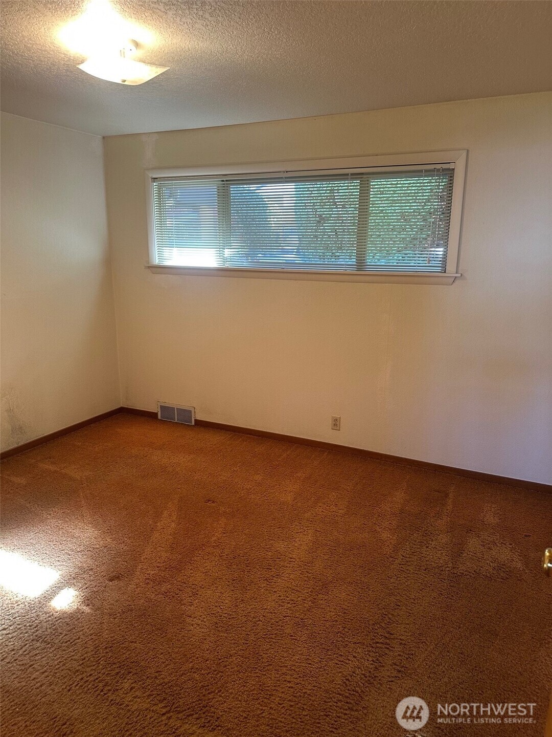 3504 Northeast 135th Street Seattle, WA 98125 - Photo 21 of 35 an empty room with a window