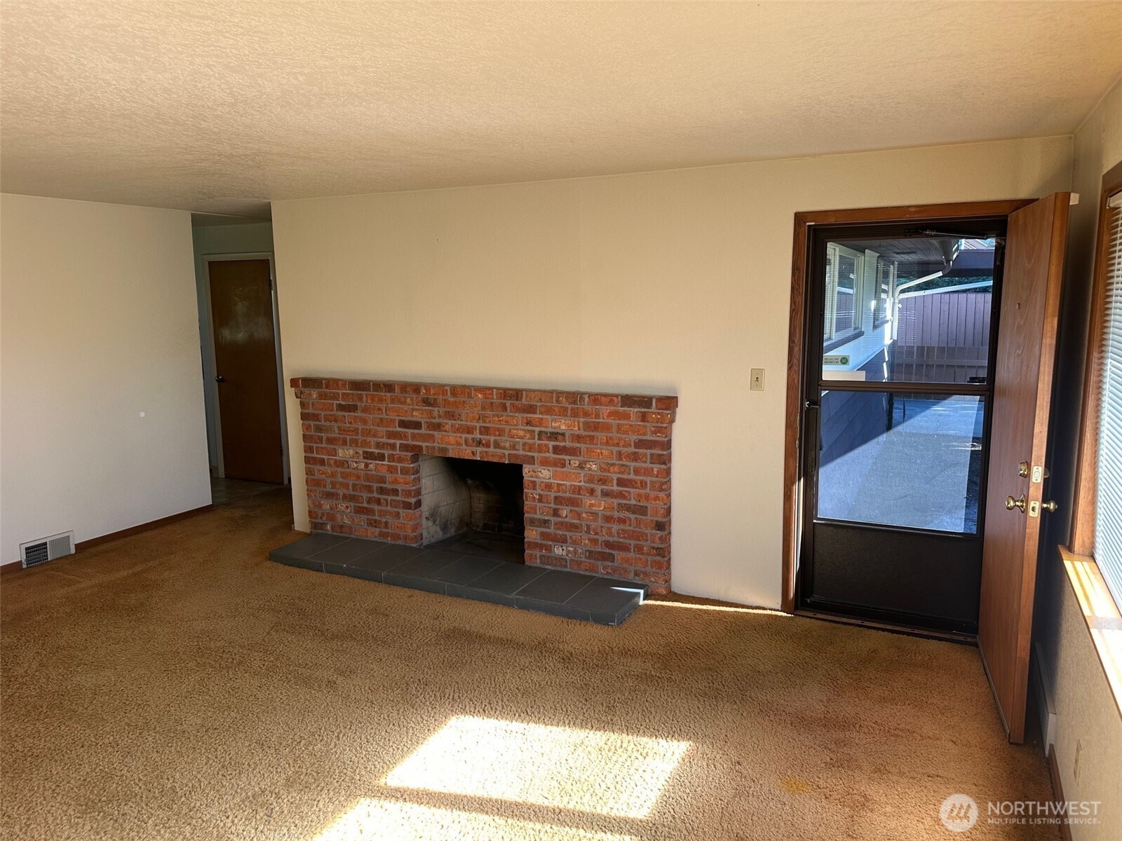 3504 Northeast 135th Street Seattle, WA 98125 - Photo 8 of 35 a view of an empty room with a fireplace