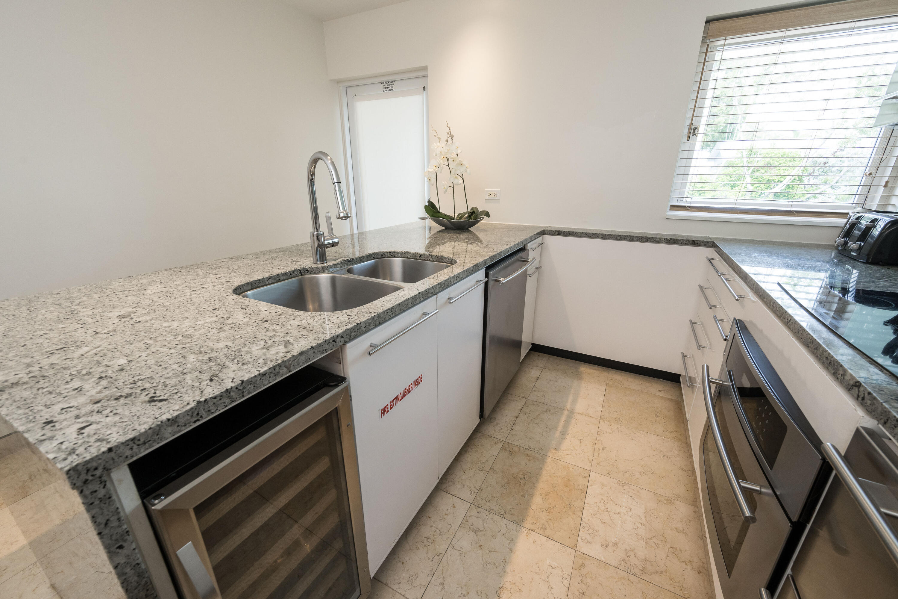 1401 Simonton Street, Unit 20 Key West, FL 33040 - Photo 11 of 32 a kitchen with a sink stove and cabinets