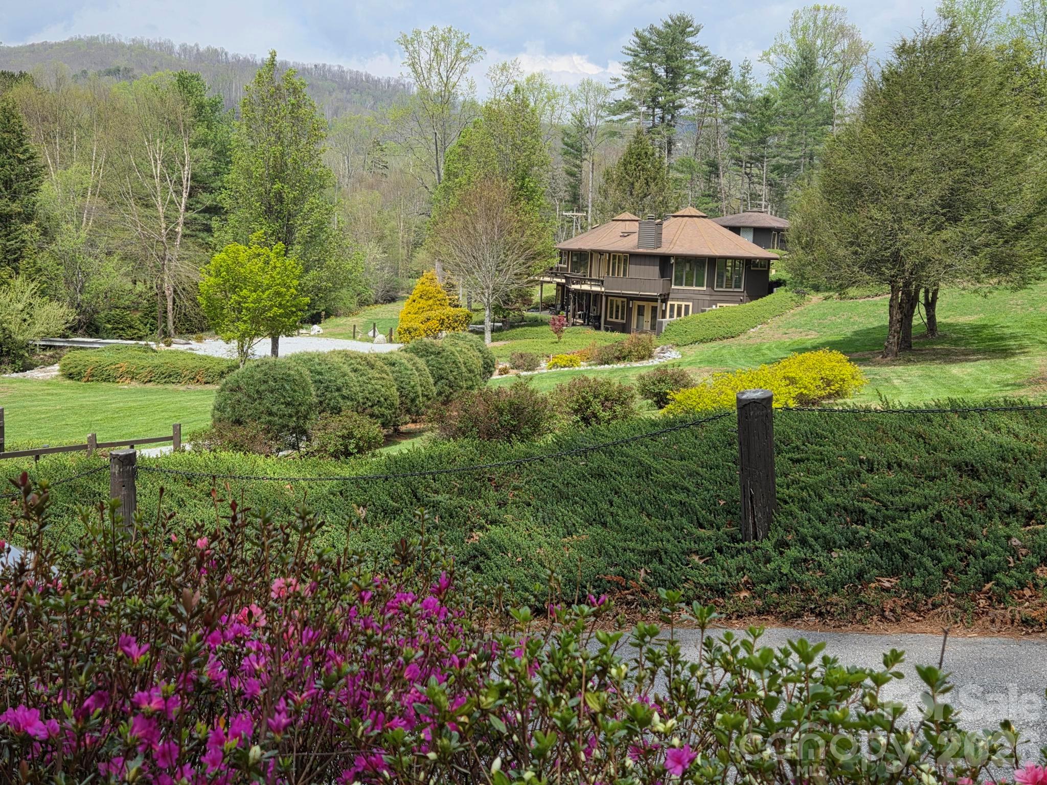 1881 Brookside Camp Road Hendersonville, NC 28792 - Photo 2 of 48 a backyard of a house with lots of green space and fountain