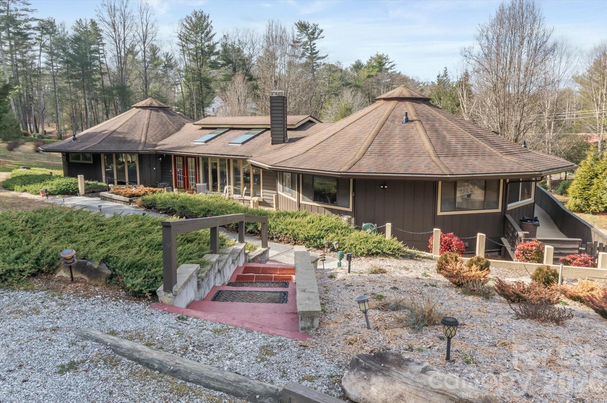 1881 Brookside Camp Road Hendersonville, NC 28792 - Photo 4 of 48 a front view of a house with garden