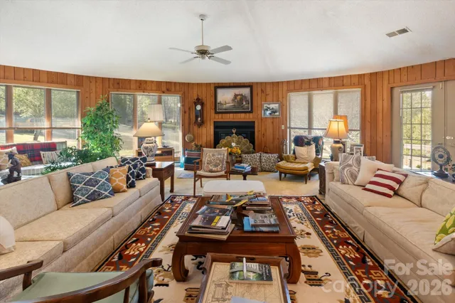 a living room with furniture a large window and a table