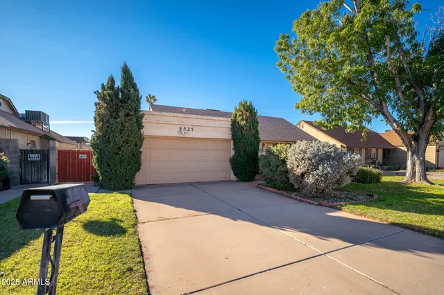 a backyard of a house with barbeque oven and outdoor seating