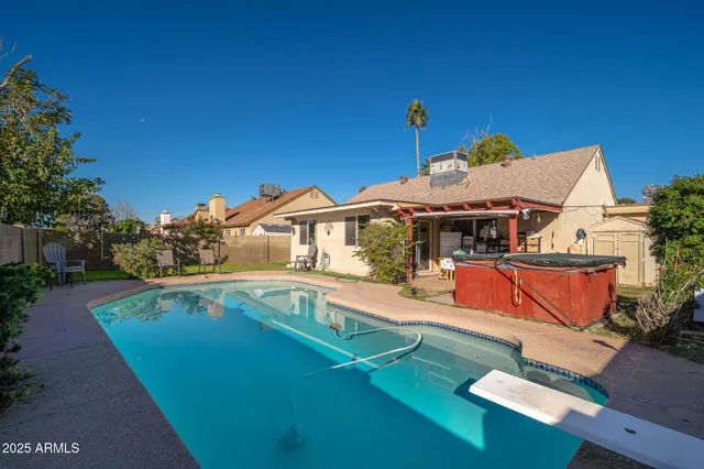 an aerial view of a house with swimming pool patio and outdoor seating
