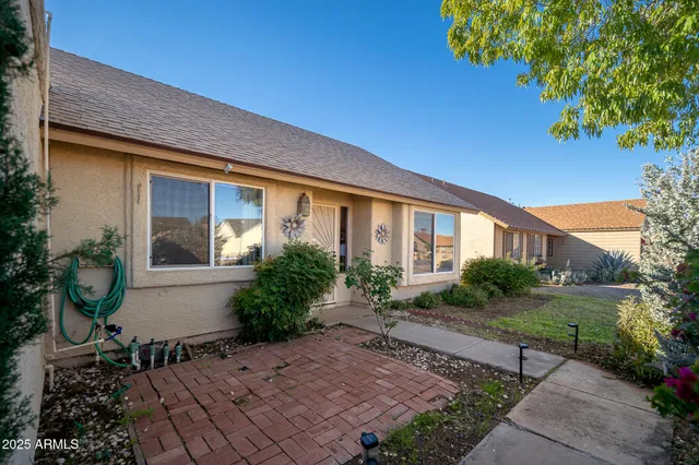 a front view of a house with garden