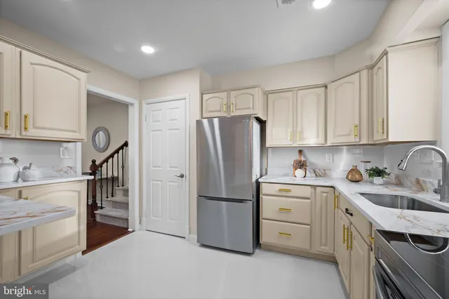 a kitchen with stainless steel appliances granite countertop a refrigerator sink and cabinets