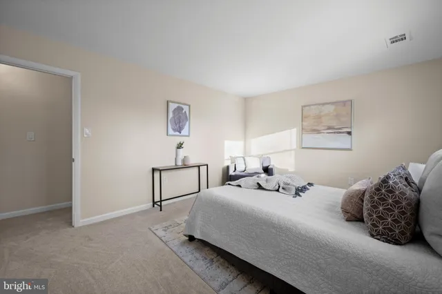 a bedroom with a bed a lamp and a window