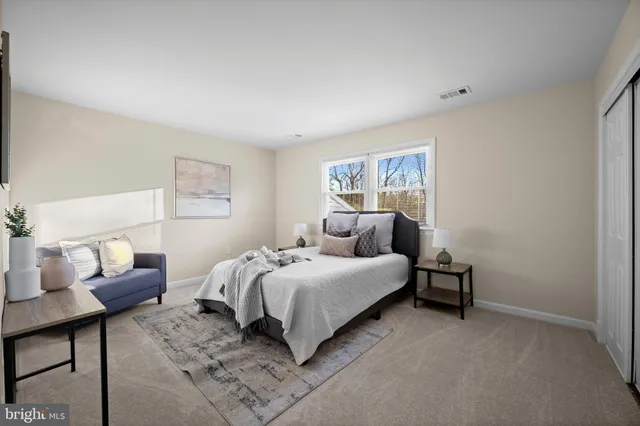 a bed room with a bed and a chair