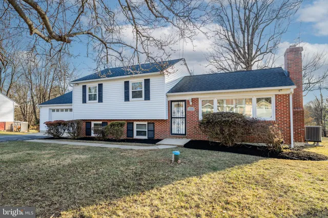 a view of a house with a yard covered in snow